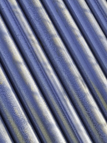 Industrial abstract New steel fence posts lying together on construction site Industrial abstract New steel fence posts lying together on construction site